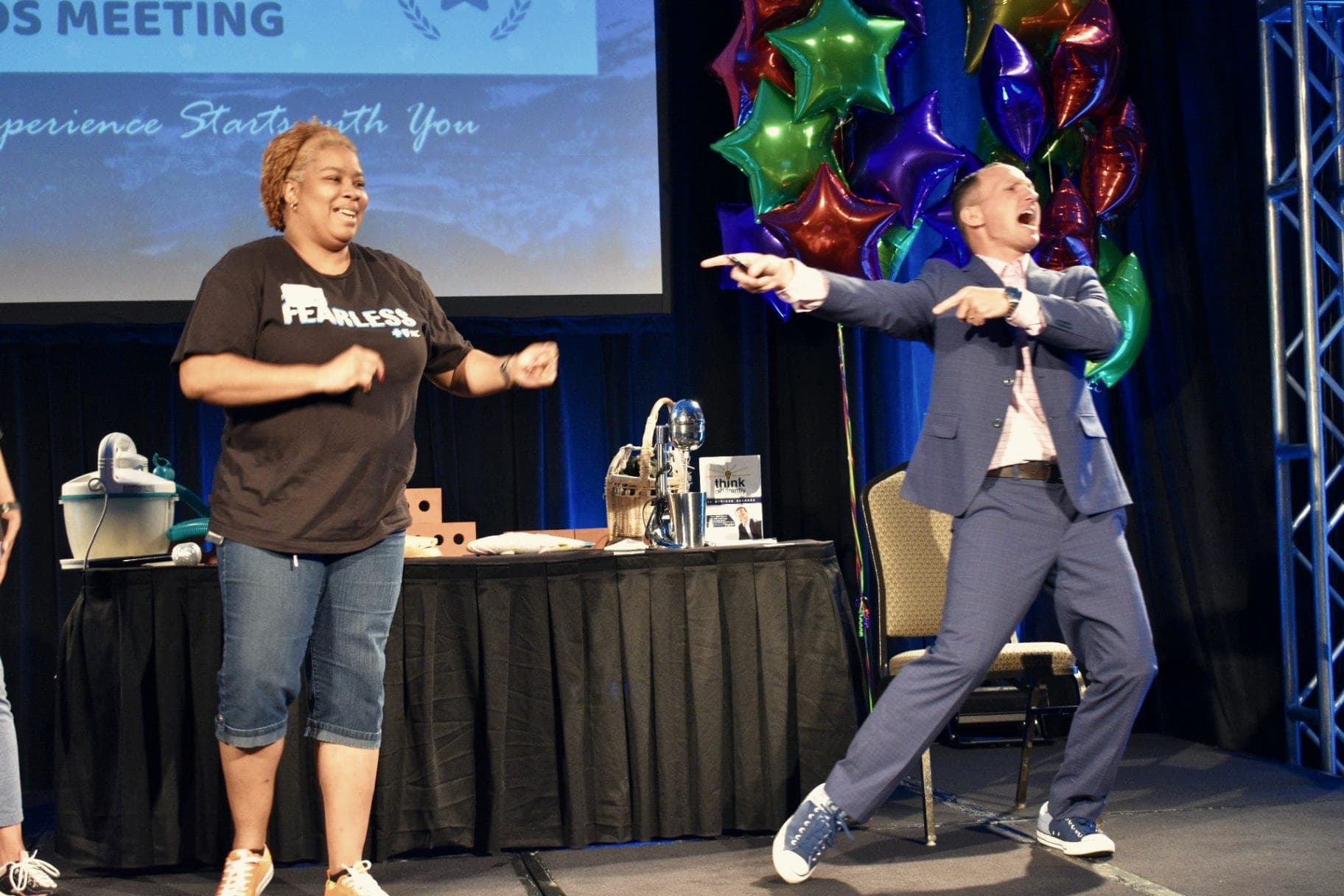 Kevin on stage with an audience member, both mid-movement